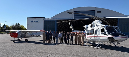 Ribbit and NRC teams gather in front of their autonomous Cessna 150 and Bell 412 aircraft.