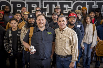 Steel Apple honoree Paul Frye with William Hardy, SVP of Supply Chain at Carhartt, and Moore Tech students.