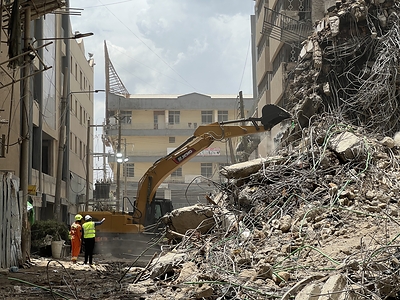 XCMG excavator operator and rescue personnel coordinate to clear debris from the collapsed building site in Nairobi