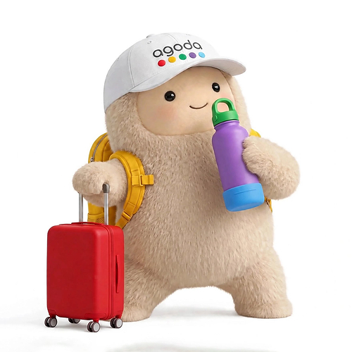 Jolly, from Meta's Muse, is shown wearing a cap with the Agoda logo and holding a water bottle next to a suitcase.