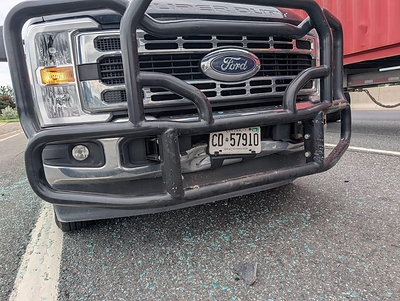 An Ex-Guard–equipped Ford F-350 after a four-vehicle pileup. The car it struck was written off, but the truck and its load came through intact.