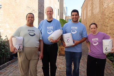 Aspire CoffeeWorks team showing off Coffee bags