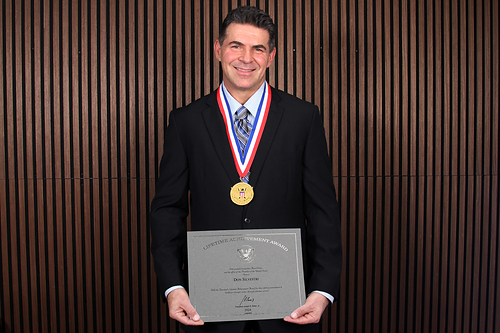Don Silvestri, President of Debt.com, proudly displays his Lifetime Achievement Award and presidential medal. Don Silvestri, President of Debt.com, proudly displays his Lifetime Achievement Award and presidential medal.