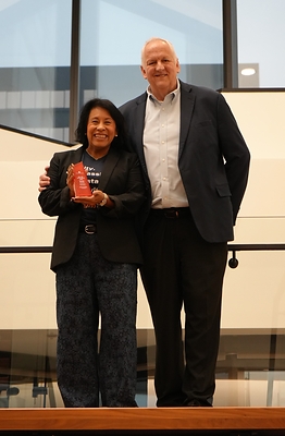 Monica Bassett (left), founder and CEO of Stronghold Food Pantry, receives Armed Forces Bank’s inaugural “Who We Honor” Award from Tom McLean, Senior Vice President and Regional Military Executive, during a surprise ceremony at the bank’s Kansas City headquarters on October 15.