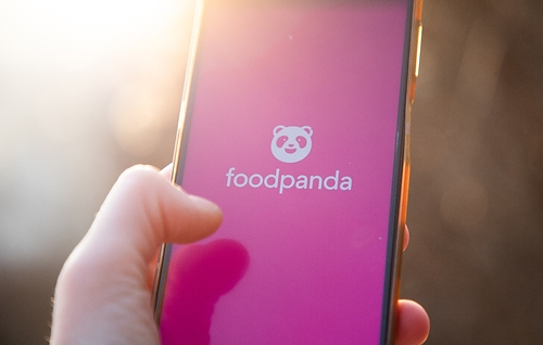 User opening up the foodpanda app on a mobile phone User opening up the foodpanda app on a mobile phone