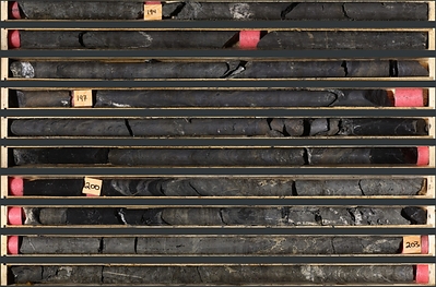 Photo 1: An interval of massive sulphide mineralization in TS26-007 consisting of massive sphalerite, and galena with minor barite and black mudstone from 193.7 to 204.1 m
