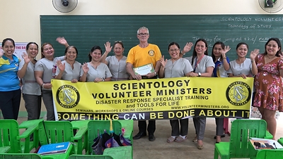 Teachers at Sindaton Elementary School, outside Davao City, Philippines, with a Scientology Volunteer Minister after a seminar on Study Technology. The school presented the Volunteer Ministers Goodwill Tour with a certificate of recognition at the close of the session.