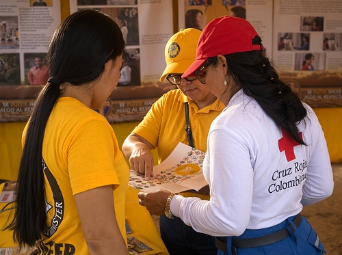 Scientology Volunteer Ministers and a Colombian Red Cross worker go over a Volunteer Ministers booklet inside the Amazon Extreme Pioneer Tour tent near Leticia, Colombia. The joint outreach day with the Red Cross and the Correcaminos Foundation drew children, parents and local volunteers. Scientology Volunteer Ministers and a Colombian Red Cross worker go over a Volunteer Ministers booklet inside the Amazon Extreme Pioneer Tour tent near Leticia, Colombia. The joint outreach day with the Red Cross and the Correcaminos Foundation drew children, parents and local volunteers.